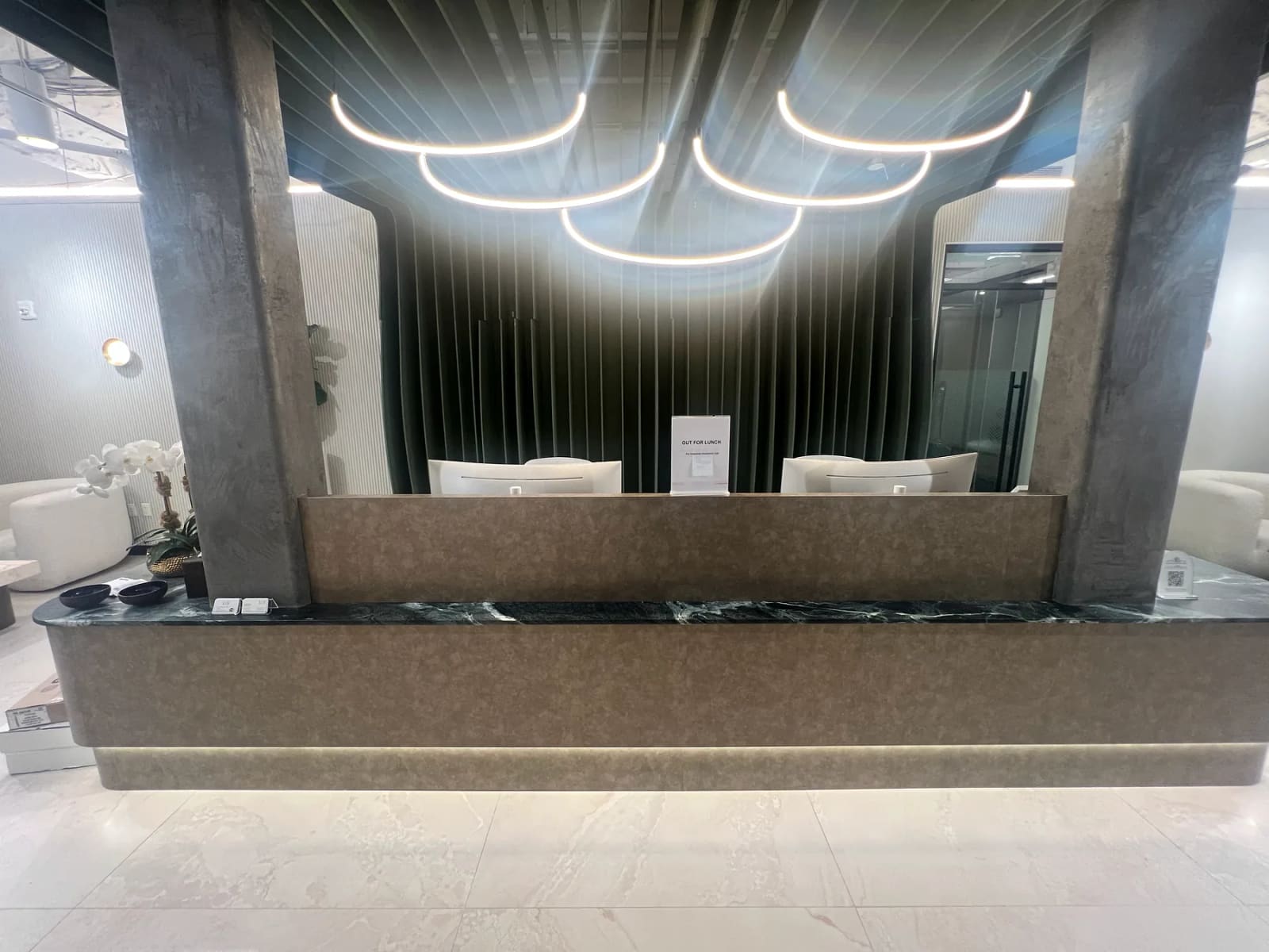 Reception desk beneath curved ceiling lights at 41 Flatbush Avenue.