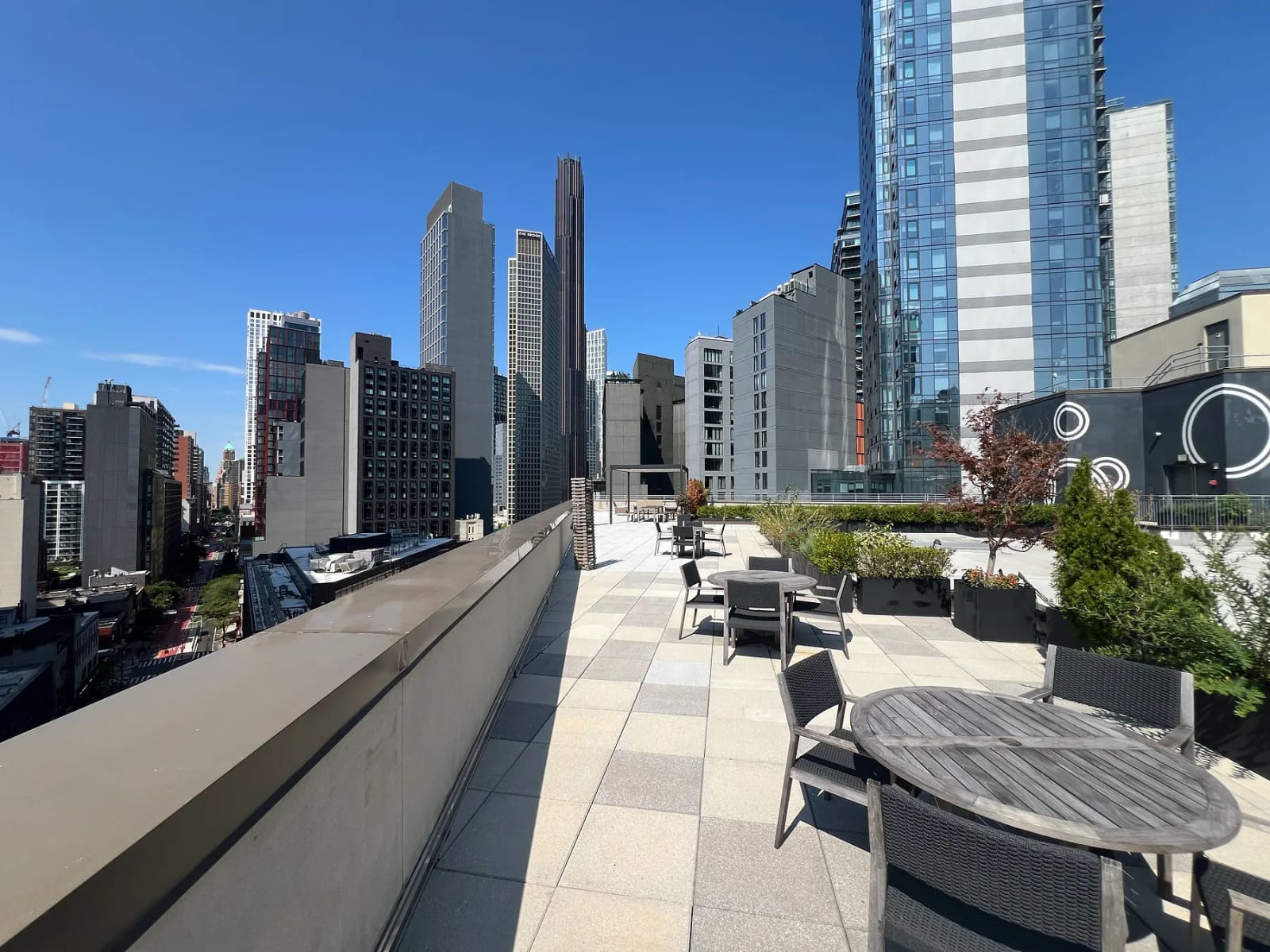 Rooftop terrace with outdoor seating and views of the Downtown Brooklyn skyline.